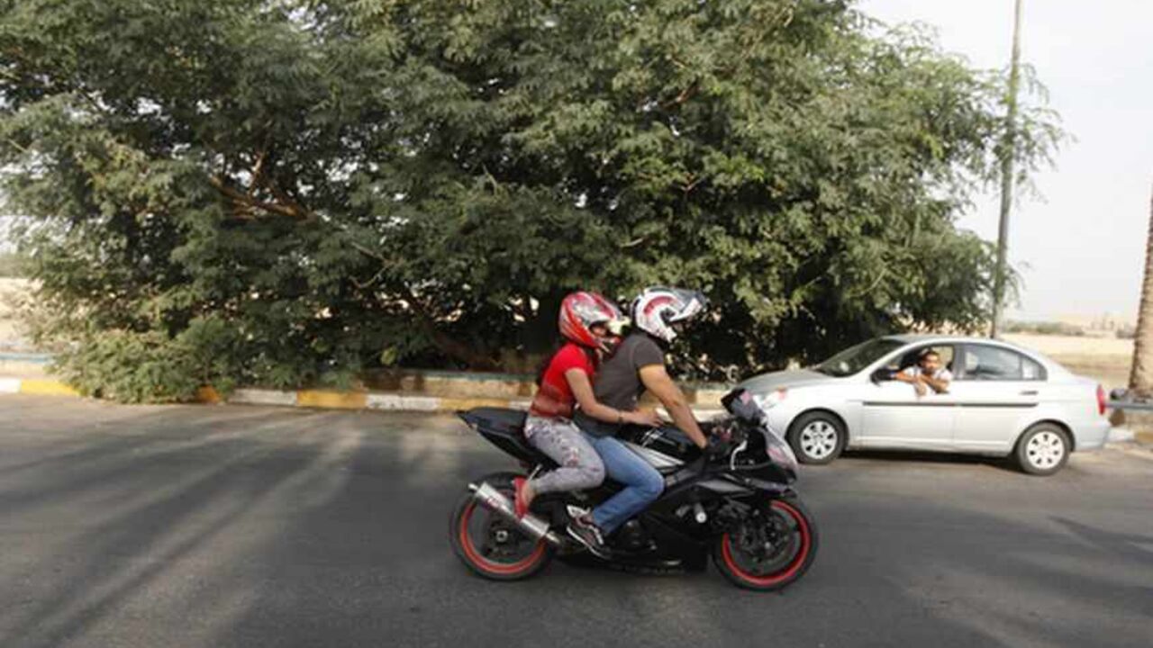 An Iraqi couple ride a motorbike during a biker show on Abu Nawas Street in Baghdad An Iraqi couple ride a motorbike during a biker show on Abu Nawas Street in Baghdad October 19, 2012. Drag-racing in California, you say? No, this is Baghdad, where youthful rebellion and American biker style clash with conservative mores in Iraq, a country where just a few years ago militias imposed their own radical Islamic views at gunpoint. Picture taken October 19, 2012. To match Feature IRAQ-CULTURE/BIKERS REUTERS/Saad Shalash (IRAQ - Tags: SOCIETY SPORT MOTORSPORT) - RTR39IOY