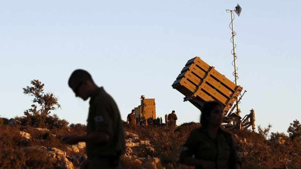 Israeli soldiers walk next to an Iron Dome missile interceptor battery as it is being positioned on the outskirts of Jerusalem Israeli soldiers walk next to an Iron Dome missile interceptor battery as it is being positioned on the outskirts of Jerusalem, September 8, 2013 REUTERS/ Ammar Awad (JERUSALEM - Tags: CONFLICT POLITICS CIVIL UNREST MILITARY) - RTX13D0G