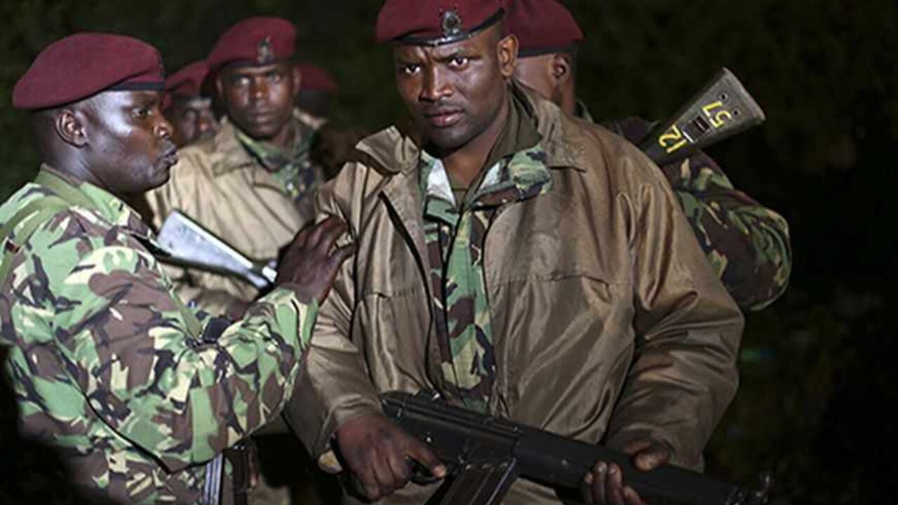 KENYA-ATTACK/ Kenyan soldiers hold their rifles near the Westgate shopping centre in Nairobi September 23, 2013. Thick smoke poured from the besieged Nairobi mall where Kenyan officials said their forces were closing in on Islamists holding hostages on Monday, three days after a raid by Somalia's al Shabaab killed at least 62 people. It remained unclear how many gunmen and hostages were still cornered in the Westgate shopping centre, two hours after a series of loud explosions and gunfire were followed by a plume of blac