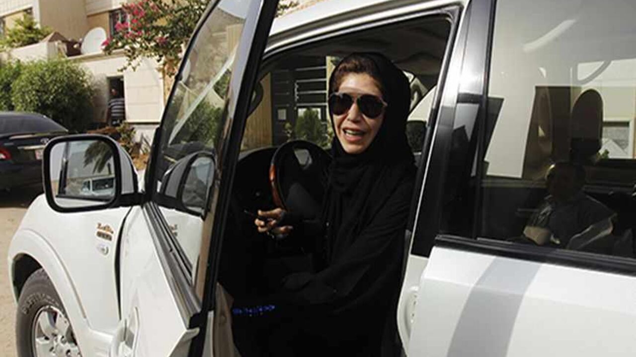 SAUDI-DRIVING/ Female driver Azza Al Shmasani alights from her car after driving in defiance of the ban in Riyadh June 22, 2011. Saudi Arabia has no formal ban on women driving. But as citizens must use only Saudi-issued licences in the country, and as these are issued only to men, women drivers are anathema. An outcry at the segregation, which contributes to the general cloistering of Saudi women, has been fuelled by social media interest in two would-be female motorists arrested in May.REUTERS/Fahad Shadeed (SAUDI ARA