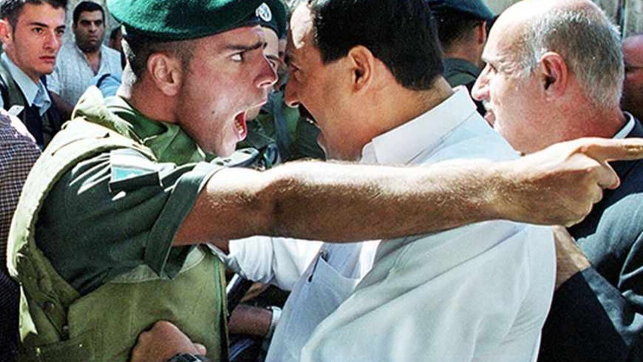 YEAREND An Israeli Border Policeman and a Palestinian scream at each other face to face in the Old City of Jerusalem October 13, 2000 as the Palestinian is refused entry to the al-Aqsa mosque for Friday prayers. Israeli security forces prevented thousands of Palestinians from attending Friday prayers over concern for continued unrest and clashes following the prayers due to the increased tensions and fighting in the West Bank and Gaza Strip. REUTERS/Amit Shabi
JWH/WS/FMS - RTRBSE2