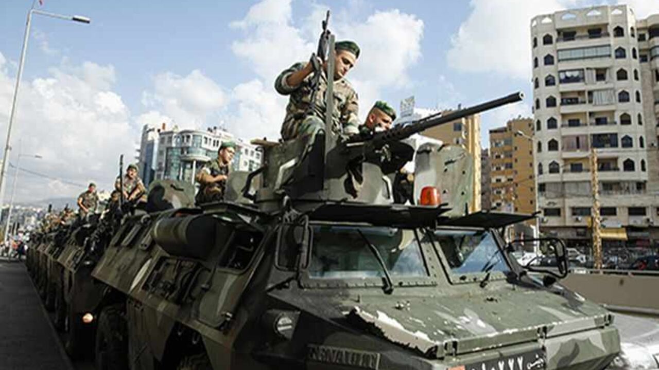 Lebanese army soldiers are deployed on their armoured vehicles in Beirut's southern suburbs September 23, 2013. Lebanese security personnel were deployed today in the southern suburbs of Beirut, part of a move to take over the checkpoints set up by Hezbollah after recent car bombings targeted the area, according to the local media. REUTERS/Sharif Karim (LEBANON - Tags: POLITICS CIVIL UNREST) - RTX13WWO