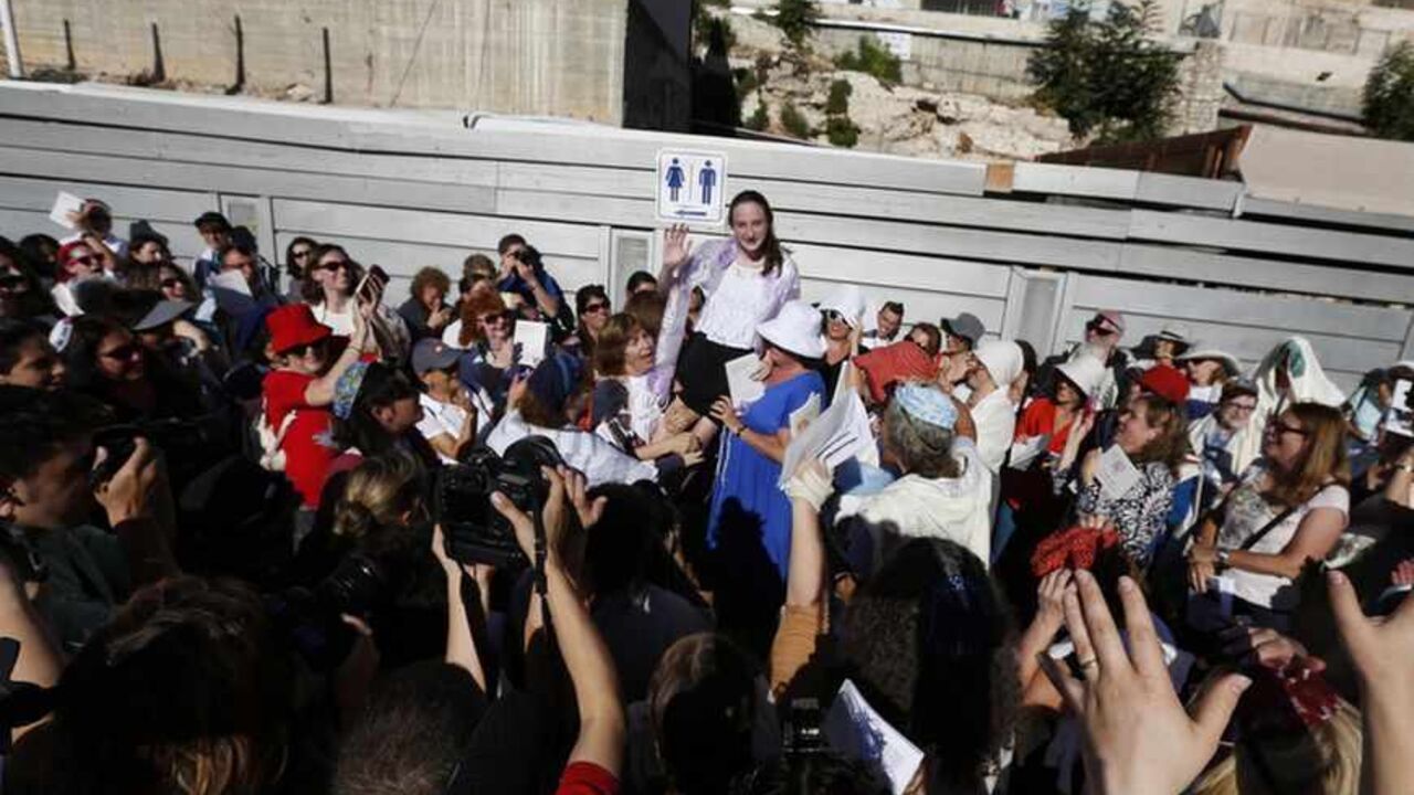 Jewish female activists from the Women of the Wall prayer rights group take part in a monthly prayer session in Jerusalem's Old City Jewish female activists from the Women of the Wall prayer rights group take part in a monthly prayer session near the Western Wall plaza in Jerusalem's Old City August 7, 2013. The activists, campaigning for equal worship rights at the holy site, held their prayer session on Wednesday without any incidences of violence occurring with Orthodox worshippers. REUTERS/Baz Ratner (JERUSALEM - Tags: POLITICS RELIGION) - RTX12CKG