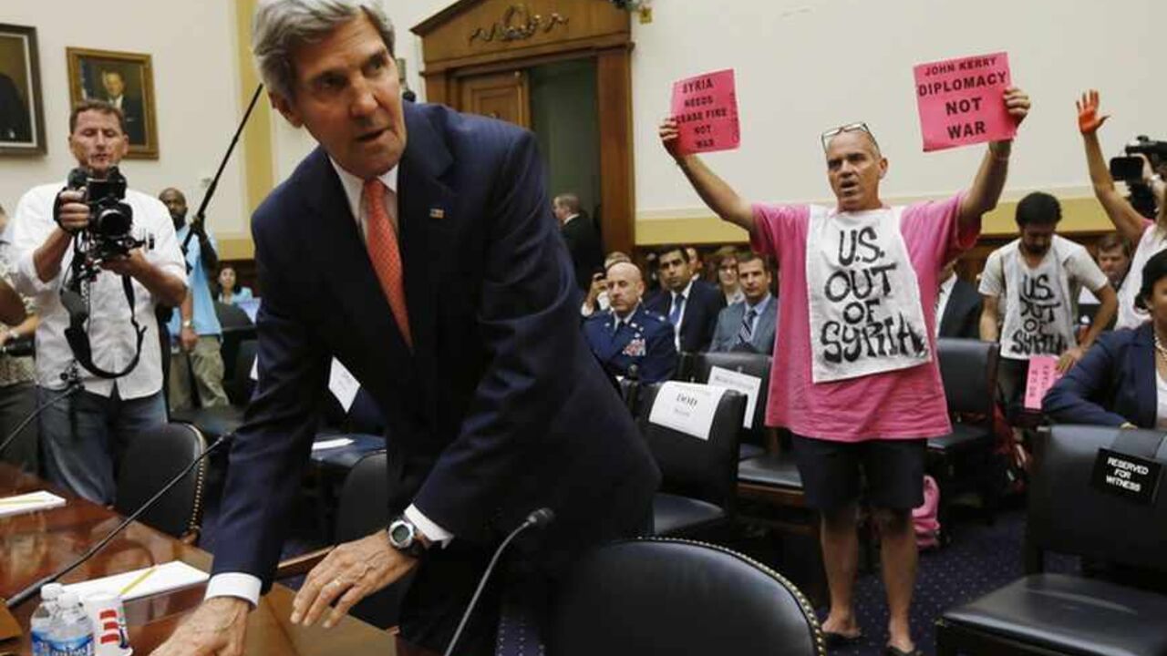 U.S. Secretary of State Kerry faces protesters against a military strike in Syria, as he arrives at a U.S. House Foreign Affairs Committee hearing in Washington U.S. Secretary of State John Kerry faces protesters against a military strike in Syria, as he arrives at a U.S. House Foreign Affairs Committee hearing on Syria on Capitol Hill in Washington, September 4, 2013. The U.S. Senate Foreign Relations Committee will likely vote later on Wednesday on a draft resolution authorizing the use of military force in Syria, several members of the panel said. REUTERS/Jason Reed (UNITED STATES - Tags: POLITICS MILITARY CONFLICT) - RTX13780