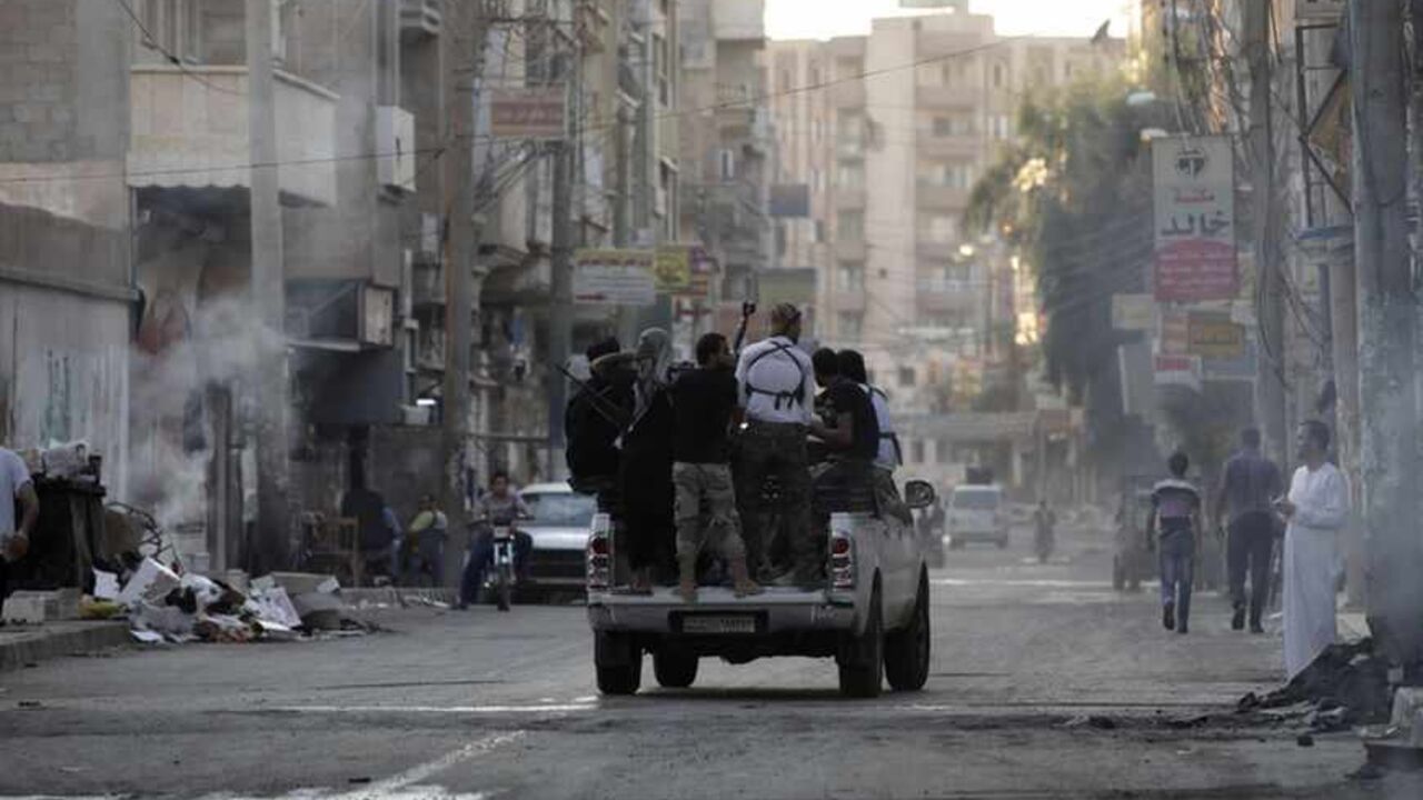 Free Syrian Army fighters ride on the back of a pickup truck in Deir al-Zor Free Syrian Army fighters ride on the back of a pickup truck in Deir al-Zor August 30, 2013. Picture taken August 30, 2013. REUTERS/Khalil Ashawi (SYRIA - Tags: POLITICS CIVIL UNREST CONFLICT MILITARY) - RTX132DY
