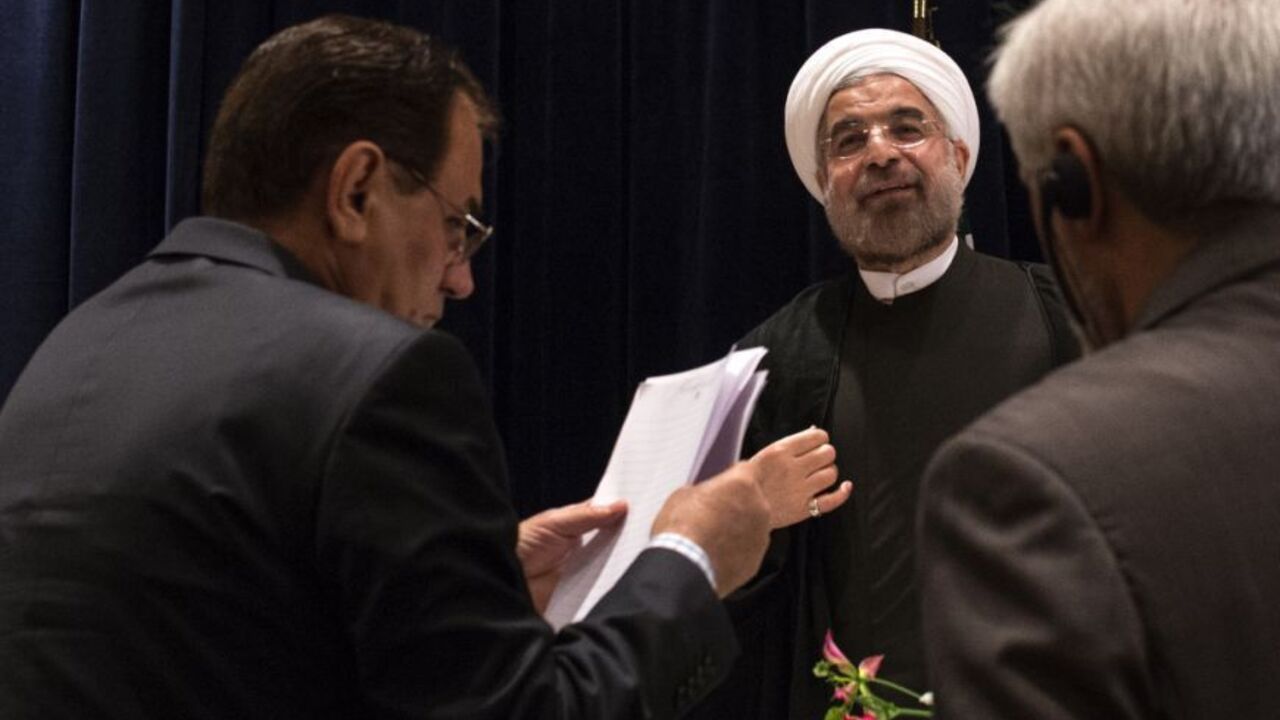 Iran's President Rouhani is approached by staff members after a news conference in New York Iran's President Hassan Rouhani (C) is approached by staff members after a news conference in New York September 27, 2013. New Iranian President Rouhani said on Friday he wanted talks with major powers on Iran's nuclear program to yield results in a short period of time and that the improved mood in U.S.-Iranian relations could lead to better ties. REUTERS/Adrees Latif (UNITED STATES - Tags: POLITICS ENERGY) - RTX142AH