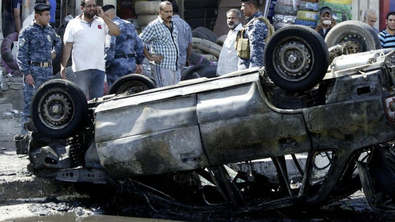 Iraqi security forces and people stand at the site of a car bomb attack in Basra Iraqi security forces and people stand at the site of a car bomb attack in Basra, 420 km (261 miles) southeast of Baghdad, October 13, 2013. A series of bombs killed at least ten people in mostly Shi'ite Muslim provinces of Iraq on Sunday ahead of the Muslim feast of Eid al-Adha, police and medical sources said. REUTERS/Essam Al-Sudani (IRAQ - Tags: CIVIL UNREST POLITICS CRIME LAW) - RTX149QD