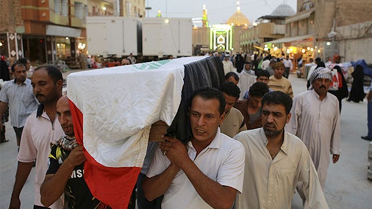 IRAQ-VIOLENCE/ Relatives carry the coffin of an Iraqi police officer killed by militants during a funeral in Najaf, around 160 km (99 miles)
south of Baghdad May 20, 2013. The attacks took place in the Sunni heartland of Anbar, where gunmen on Saturday ambushed and kidnapped 10 policemen near the provincial capital of Ramadi, and four members of a government-backed Sunni militia fighters were killed near Falluja city When Sunni-Shi'ite bloodshed was at its height in 2006-07, Anbar, which shares a border with Syria, was i