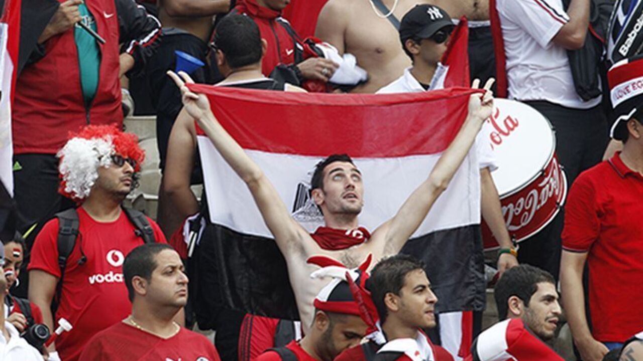 Fans of the Egypt team celebrate during their World Cup 2014 African zone qualifying soccer match against Ghana at the Baba Yara Sports Stadium in Kumasi October 15, 2013.  REUTERS/Luc Gnago (GHANA - Tags: SPORT SOCCER) - RTX14CVU
