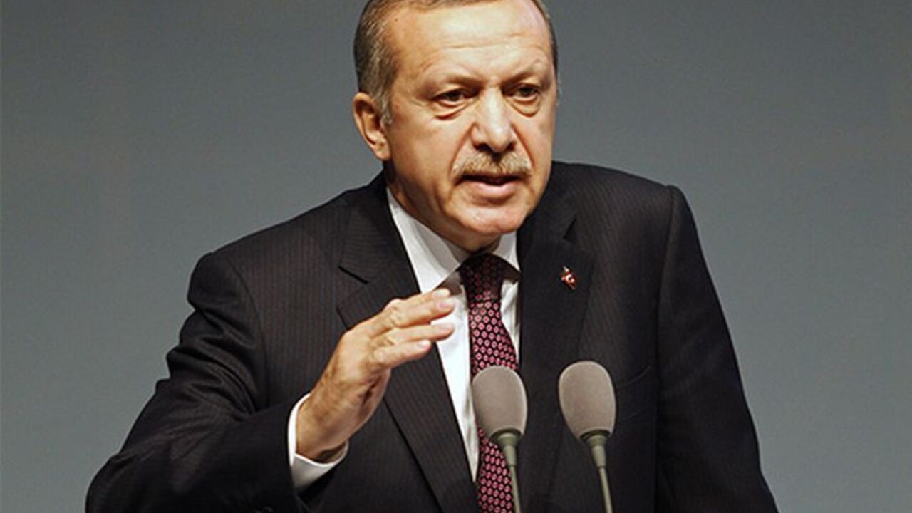 TURKEY/ Turkey's Prime Minister Tayyip Erdogan address an audience during the European Bank for Reconstruction and Development's (EBRD) 2013 Annual Meeting and Business Forum in Istanbul May 10, 2013. Erdogan said Turkey would support a U.S.-enforced no-fly zone in Syria and warned that Damascus crossed President Barack Obama's "red line" on chemical weapons use long ago, according to an NBC News interview released Thursday. REUTERS/Osman Orsal (TURKEY - Tags: POLITICS BUSINESS) - RTXZH9Z