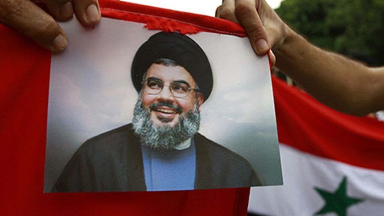 TUNISIA Protesters shout slogans as they hold an image of Lebanon's Hezbollah leader Sayyed Hassan Nasrallah during a demonstration against the possibility of a U.S. military strike against the Syrian government, in Tunis September 10, 2013. REUTERS/Anis Mili (TUNISIA - Tags: POLITICS CIVIL UNREST) - RTX13G1N