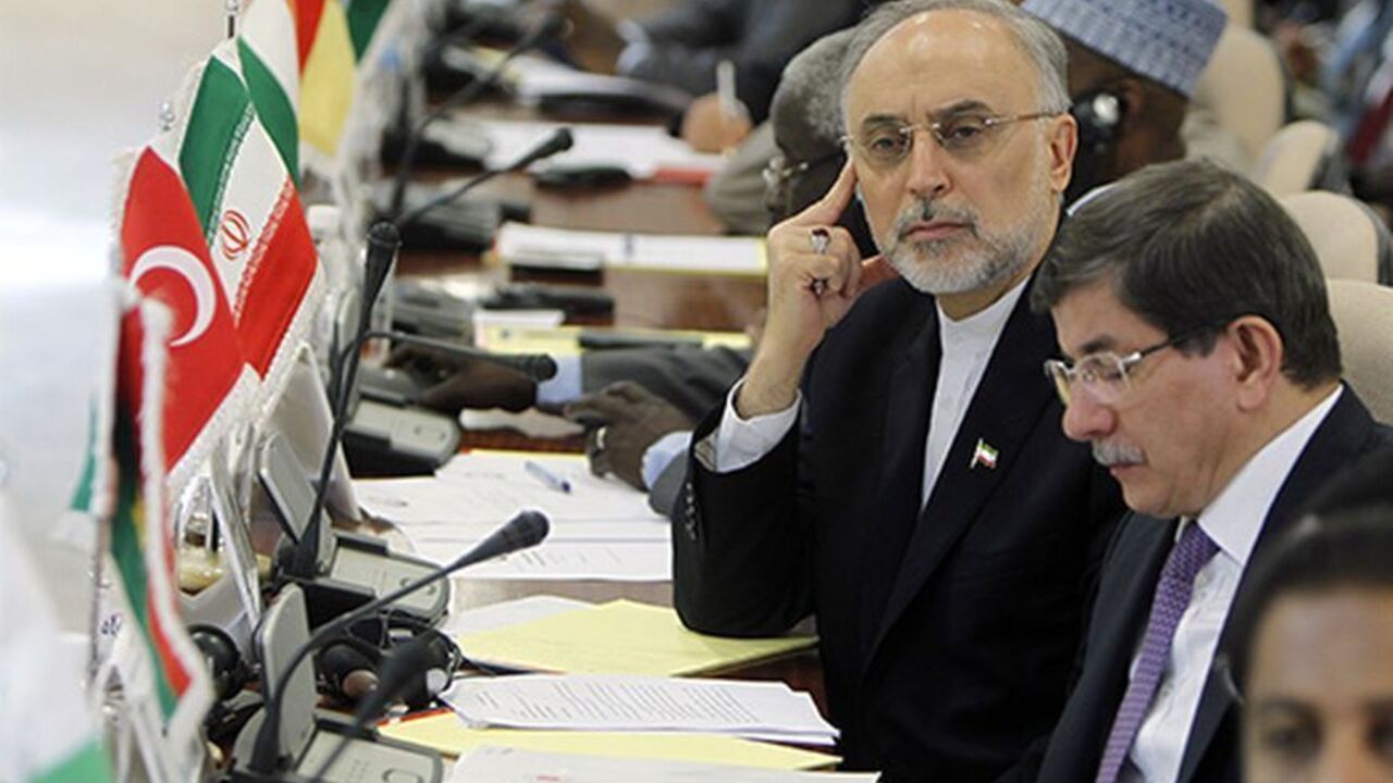 Nic6215523 Iranian Foreign Minister Ali Akbar Salehi (L) looks past his Turkish counterpart Ahmet Davutoglu (2nd R) during the opening of a ministerial meeting in the Saudi Red Sea city of Jeddah, by the Organisation of Islamic Cooperation (OIC) on May 13, 2013. The OIC urged its member states to make generous contributions at this week's main donors conference on Mali to be held in Brussels, which aims to raise funds to repair the damage caused by the war against Islamists in the African country. AFP PHOTO/STR