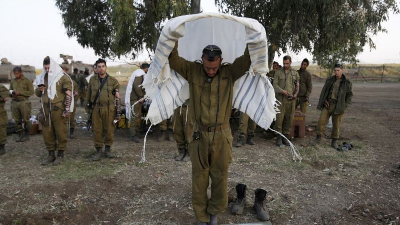 Israeli soldiers pray close to the ceasefire line between Israel and Syria on the Golan Heights Israeli soldiers from the Golani Brigade pray close to the ceasefire line between Israel and Syria on the Israeli occupied Golan Heights May 7, 2013. Israel played down weekend air strikes close to Damascus reported to have killed dozens of Syrian soldiers, saying they were not aimed at influencing its neighbour's civil war but only at stopping Iranian missiles reaching Lebanese Hezbollah militants.
REUTERS/Baz Ratner (MILITARY RELIGION) - RTXZDAS