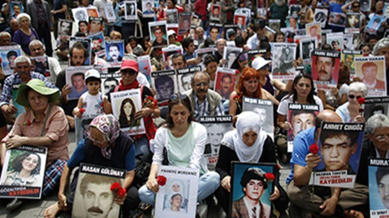 Turkish Kurdish people hold pictures of their relatives who were killed in clashes between Kurdistan Workers' Party (PKK) guerrillas and Turkish security forces, during a demonstration in central Istanbul June 8, 2013. More than 40,000 people have been killed in the separatist conflict in southeast Turkey since the Kurdistan Workers Party (PKK) took up arms against the state in 1984.   REUTERS/Stoyan Nenov (TURKEY - Tags: POLITICS CIVIL UNREST) - RTX10G9A