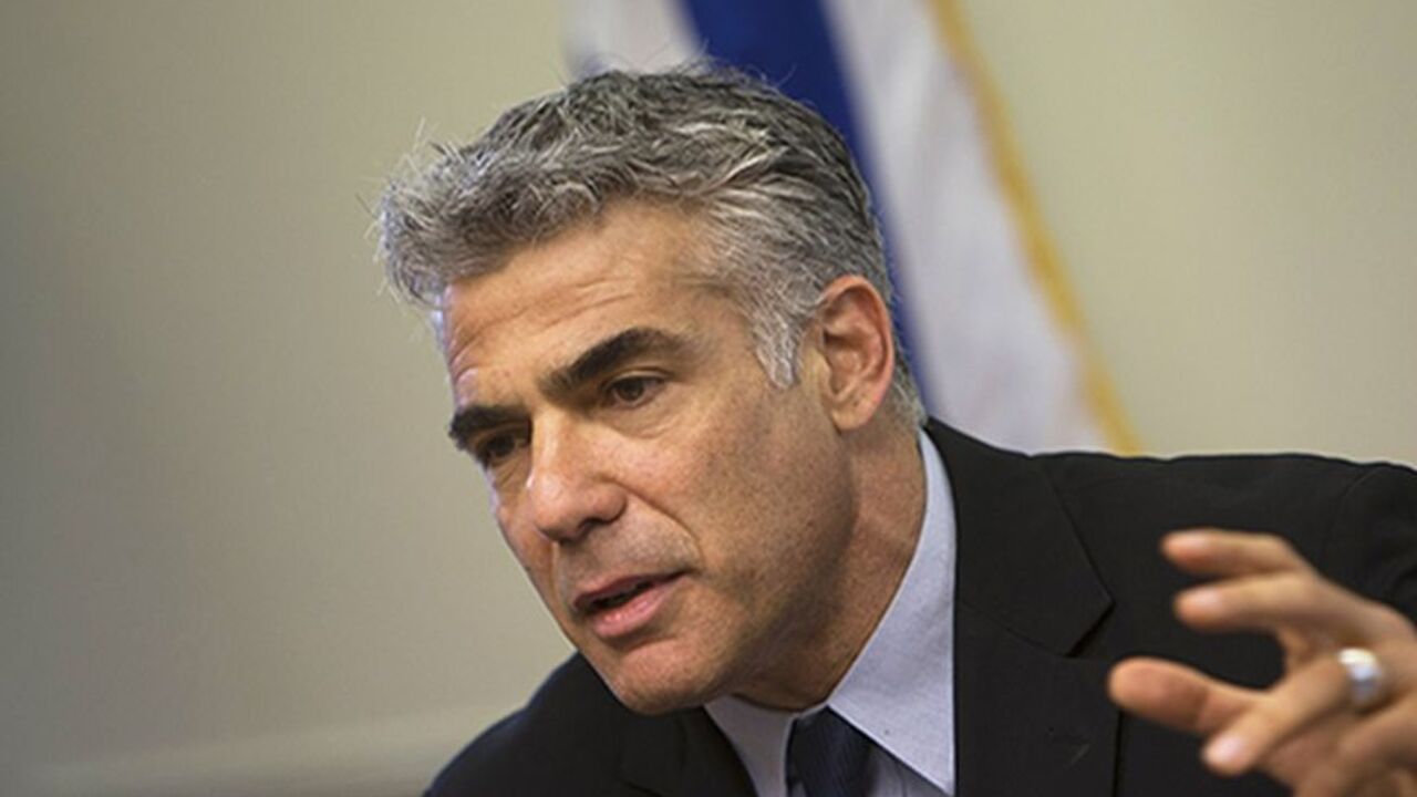 PALESTINIANS-ISRAEL/ Israel's Finance Minister Yair Lapid gestures as he speaks during a Yesh Atid party meeting at the Knesset, the Israeli parliament, in Jerusalem May 20, 2013. Lapid, whose new centrist party is the second largest in Israel's government, said on Monday thousands of Jewish settlers would have to be removed from occupied land under any peace deal with the Palestinians. REUTERS/Ronen Zvulun (JERUSALEM - Tags: POLITICS) - RTXZTWQ