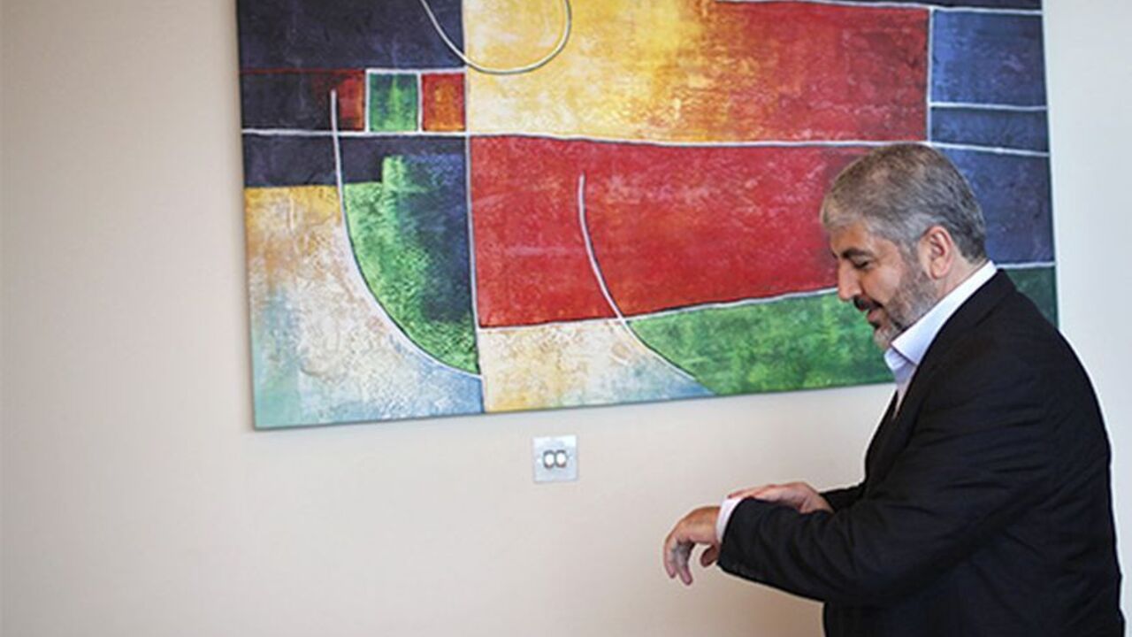 PALESTINIANS-MESHAAL/ Hamas leader Khaled Meshaal looks at his watch before his interview with Reuters in Doha November 29, 2012. Meshaal said the de facto recognition of a sovereign Palestinian state won by his rival Mahmoud Abbas should be seen alongside Gaza's latest conflict with Israel as a single, bold strategy that could empower all Palestinians. Meshaal said the short war which claimed 162 Palestinian lives and five Israelis was concluded on terms set by the Palestinian Islamist movement and ended its isolation, creating