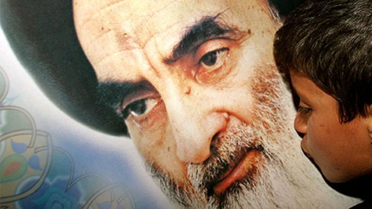 IRAQ An Iraqi Shi'ite Muslim boy kisses a poster of the Ayatollah Ali al-Sistani in the town of Karbala, some 110 km south from the Iraqi capital Baghdad, early February 6, 2004. Iraq's most powerful Shi'ite cleric, Ayatollah Ali al-Sistani, survived an assassination bid on Thursday when gunmen opened fire on his entourage in the sacred streets of Najaf, a security aide said. The assassination attempt comes days before a team of United Nations electoral experts is due to arrive in the country to assess the feasi