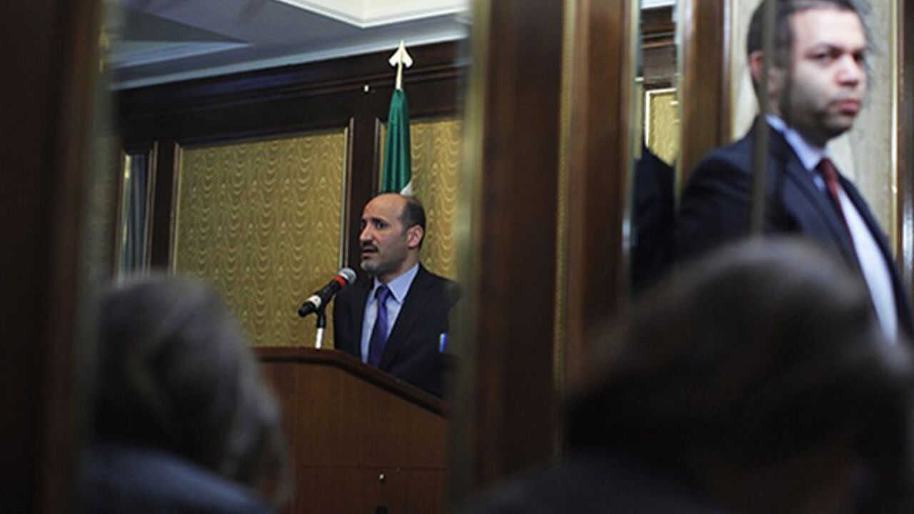 USA/ Ahmad Jarba (L), head of the opposition Syrian National Coalition, is seen reflected in a mirror as he attends a news conference about chemical weapons in New York, September 27, 2013. REUTERS/Eduardo Munoz (UNITED STATES - Tags: POLITICS CONFLICT) - RTX142FX