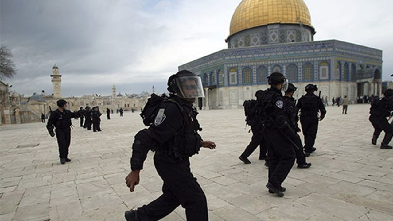 PALESTINIANS-ISRAEL/PRISONERS Israeli border police run in front of Dome of the Rock during a protest after Friday prayers at a compound known to Muslims as al-Haram al-Sharif and to Jews as Temple Mount, in Jerusalem's Old City February 22, 2013. Palestinian protesters have said they fear for the life of Samer al-Issawi, who has been on intermittent hunger strike for over 200 days, and three other hunger strikers jailed by Israel. Their cases have been at the centre of intensified clashes with Israeli soldiers throughout the Israeli-oc