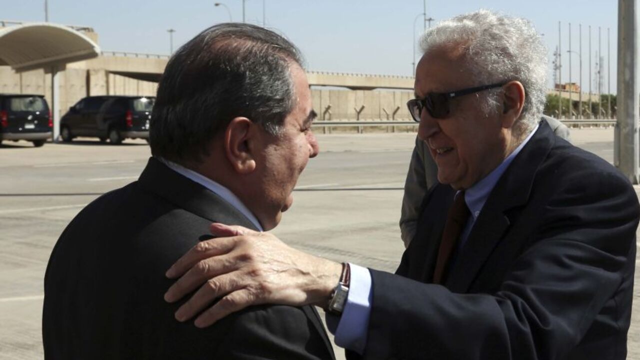IRAQ-SYRIA/BRAHIMI U.N. envoy to Syria, Lakhdar Brahimi (R), is welcomed by Iraqi Foreign Minister Hoshyar Zebari after arriving at Baghdad International Airport October 21, 2013. International envoy for Syria Brahimi was in Baghdad on Monday to discuss dates for peace talks aimed at ending the war in Syria. Brahimi said no date had yet been set for the long-delayed conference. International efforts to end the 2-1/2 year conflict that has killed more than 100,000 people have stuttered. But a deal last month for Syria to get r