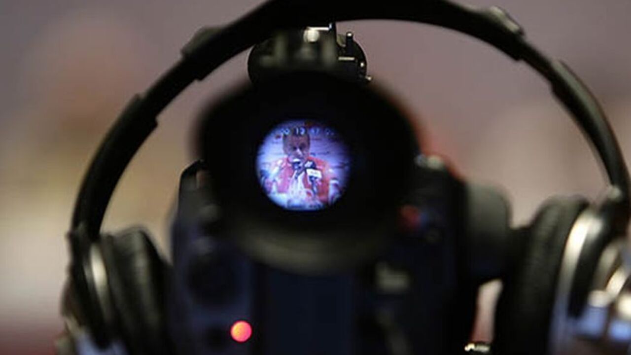 SOCCER-WORLD/SWITZERLAND Head coach of the Swiss national soccer team Ottmar Hitzfeld is shown on a video camera during a news conference in Tel Aviv September 5, 2008. The Swiss national soccer team will play Israel in their first World Cup 2010 qualification match on Saturday. REUTERS/Stefan Wermuth (ISRAEL) - RTX8FMX