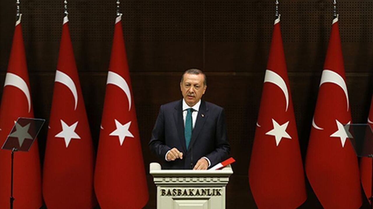 TURKEY-REFORM/ Turkish Prime Minister Tayyip Erdogan addresses the media in Ankara September 30, 2013. Turkey will end a ban that bars women from wearing the Islamic-style headscarf in state institutions, part of the government's long-awaited package of proposed human-rights reforms, Erdogan said on Monday in a major policy speech. The new rules will not apply to the judiciary or the military. Muslim but secular Turkey has long had tough restrictions on the garb worn by women working in state offices. Erdogan also announc