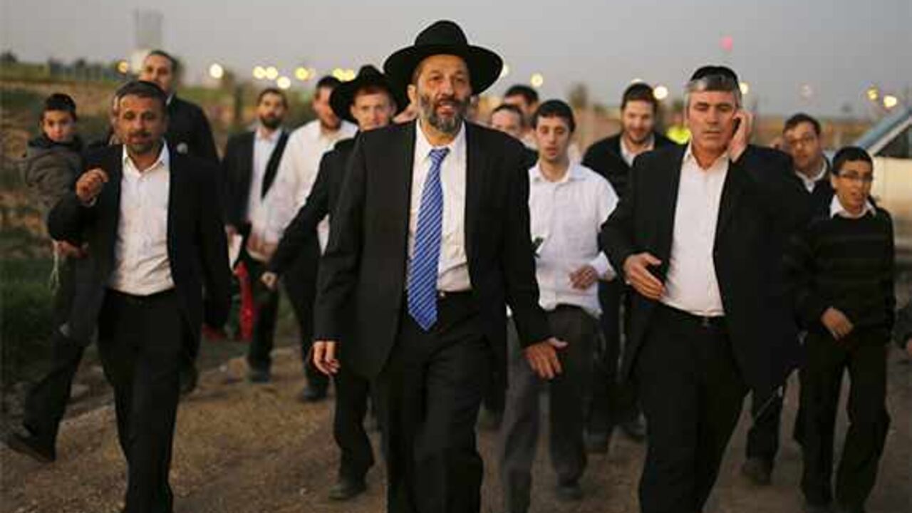 ISRAEL-ELECTION/ULTRAORTHODOX Aryeh Deri (C), leader of the ultra-Orthodox Shas party, attends an annual pilgrimage to the gravesite of Rabbi Yisrael Abuhatzeira, a Moroccan-born sage and kabbalist also known as the Baba Sali, in the southern town of Netivot January 14, 2013. Powerful political players for years, Israel's ultra-Orthodox parties must now reckon with a new force ushered in by voters bent on stripping them of perks they have relied on for decades. Picture taken January 14, 2013. REUTERS/Amir Cohen (ISRAEL - Tags: POLITICS