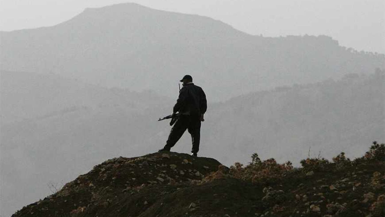 TURKEY-IRAQ/ A Kurdish village guard stands top of the hill in the southeastern Turkish province of Sirnak October 26, 2007. President Abdullah Gul warned Kurdish rebels on Thursday that Turkey's patience was running out after Turkish forces said they had repelled a guerrilla attack near the Iraqi border. REUTERS/Osman Orsal (TURKEY) - RTR1VC7F