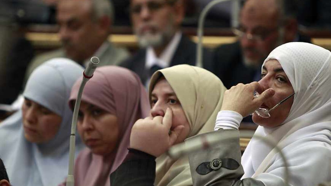 EGYPT Female Members of Parliament, who are also members of the Freedom and Justice Party of the Muslim Brotherhood, attend a parliament session in Cairo February 26, 2012. Egypt's military rulers invited the parliament's two houses to convene on Saturday to elect an assembly tasked with writing the country's first constitution since the overthrowing of former President Hosni Mubarak. REUTERS/Amr Abdallah Dalsh (EGYPT - Tags: CIVIL UNREST POLITICS) - RTR2YH3N