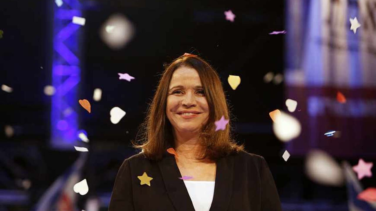 ISRAEL-ELECTION/ Confetti drops as Labour party leader Shelly Yachimovich stands on stage during an event to mark the end of the party campaign in Tel Aviv January 17, 2013. Opinion polls have shown Labour, which ruled Israel for decades but now holds only eight seats in parliament, bouncing back to second place behind Likud under new leader Yachimovich. REUTERS/Baz Ratner (ISRAEL - Tags: POLITICS ELECTIONS) - RTR3CKNE