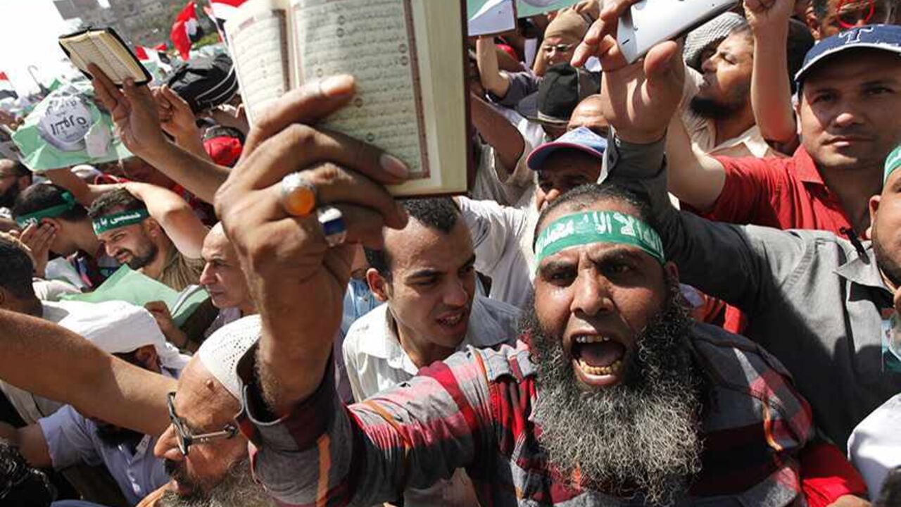 EGYPT-PROTESTS/ Islamists, members of the brotherhood, and supporters of Egyptian President Mohamed Mursi shout slogans during a protest around the Raba El-Adwyia mosque square in the suburb of Nasr City, Cairo, June 28, 2013. Egypt's leading religious authority warned of "civil war" on Friday and called for calm after a member of the ruling Muslim Brotherhood was killed ahead of mass rallies aimed at forcing the president to quit. REUTERS/Mohamed Abd El Ghany (EGYPT - Tags: POLITICS CIVIL UNREST) - RTX114YI
