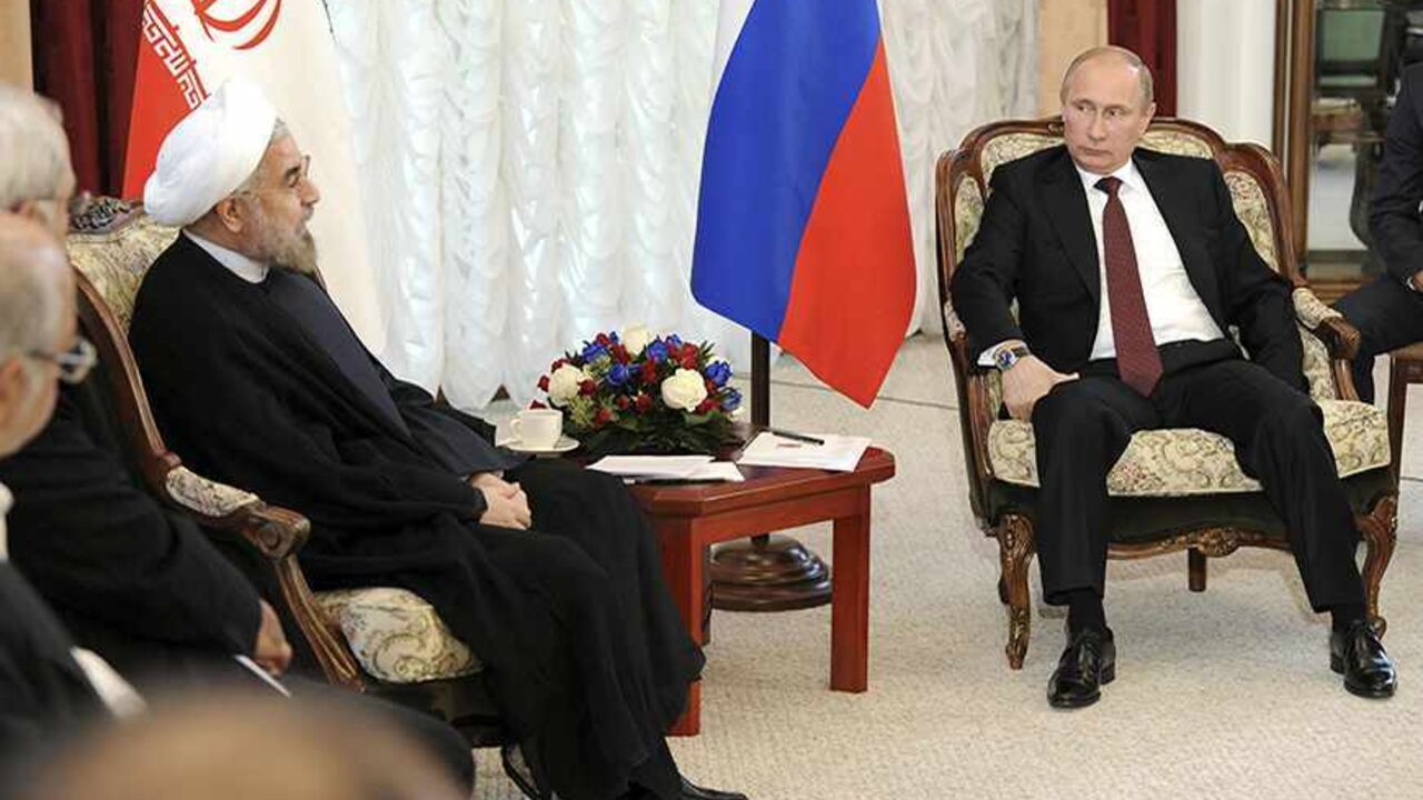 IRAN-NUCLEAR/DISPUTE Russia's President Vladimir Putin (R) meets with his Iranian counterpart Hassan Rouhani during the Shanghai Cooperation Organization (SCO) summit in Bishkek, September 13, 2013. Rouhani said on Friday that he wanted a swift resolution to a dispute over Tehran's nuclear programme, which Western states fear is aimed at developing nuclear weapons. REUTERS/Mikhail Klimentyev/RIA Novosti/Kremlin (KYRGYZSTAN - Tags: POLITICS) ATTENTION EDITORS - THIS IMAGE HAS BEEN SUPPLIED BY A THIRD PARTY. IT IS DISTRIBUTED, E