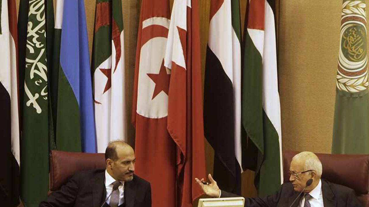 SYRIA-CRISIS/OPPOSITION Arab League Secretary General Nabil al-Arabi (R) speaks to President of the Syrian National Coalition Ahmad Jarba during the Arab foreign ministers' meeting in Cairo November 3, 2013. The Syrian opposition set terms on Sunday for attending peace talks to end the Syrian civil war, in a move that throws the proposed conference into further confusion after the international envoy said there should be no preconditions. REUTERS/Mohamed Abd El Ghany (EGYPT - Tags: POLITICS) - RTX14Z0R