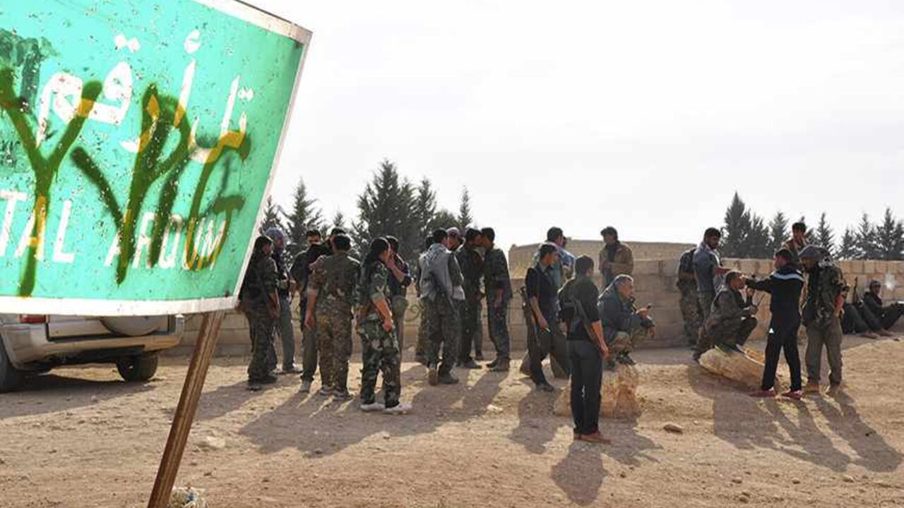 Members of the Kurdish People's Protection Units (YPG) carry their weapons as they gather in Tal Arqum, near the city of Ras al- Ain, after capturing it from Islamist rebels November 5, 2013. Redur Xelil, spokesman for the armed wing of the Syrian Kurdish Democratic Union Party (PYD), said Kurdish militias had seized the city of Ras al-Ain and all its surrounding villages. Syrian Kurdish fighters have captured more territory from Islamist rebels in northeastern Syria, a Kurdish militant group said on Monday