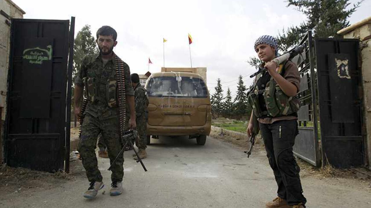 SYRIA-CRISIS/ Members of Kurdish People's Protection Units (YPG) walk after capturing a military base that belonged to the Islamist rebels near Ras al-Ain, in the province of Hasakah, November 6, 2013. Redur Xelil, spokesman for the armed wing of the Syrian Kurdish Democratic Union Party (PYD), said Kurdish militias had seized the city of Ras al-Ain and all its surrounding villages. Syrian Kurdish fighters have captured more territory from Islamist rebels in northeastern Syria, a Kurdish militant group said on Monday, ti