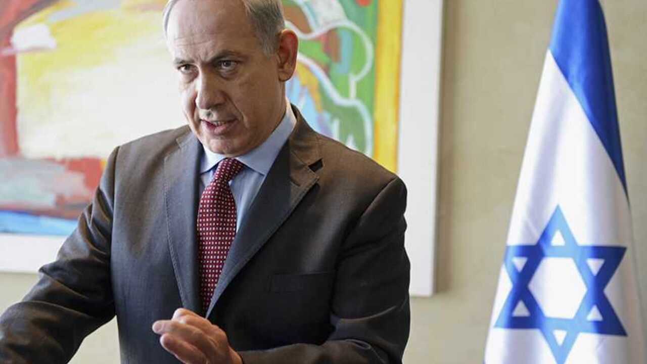 IRAN-NUCLEAR/ Israeli Prime Minister Benjamin Netanyahu gestures as he delivers a statement to the media after meeting U.S. Secretary of State John Kerry at Ben Gurion Airport near Tel Aviv November 8, 2013. Israel rejected out of hand on Friday a mooted deal between world powers and Iran, just as Kerry prepared to join nuclear talks that aim to nail down an interim agreement on the decade-old standoff. REUTERS/Debbie Hill/Pool (ISRAEL - Tags: POLITICS) - RTX1555A