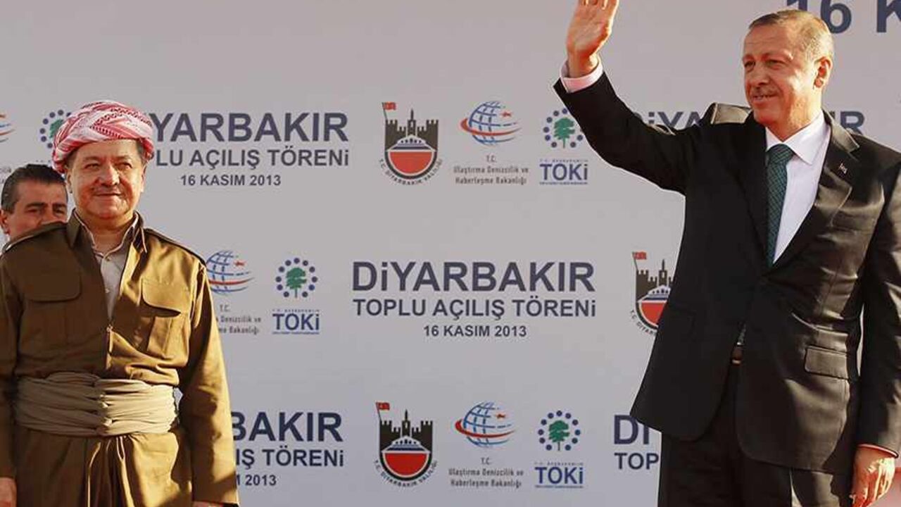 TURKEY-KURDISTAN/ Turkey's Prime Minister Tayyip Erdogan (R) and President of Iraqi Kurdistan Masoud Barzani greet people during a ceremony in Diyarbakir November 16, 2013. The president of Iraqi Kurdistan called on Turkey's Kurds to back a flagging peace process with Ankara on Saturday, making his first visit to southeastern Turkey in two decades in a show of support for PM Erdogan. Barzani's trip to Diyarbakir, the main city in Turkey's Kurdish-dominated southeast, comes as Ankara finalises billions of dollars of energy d