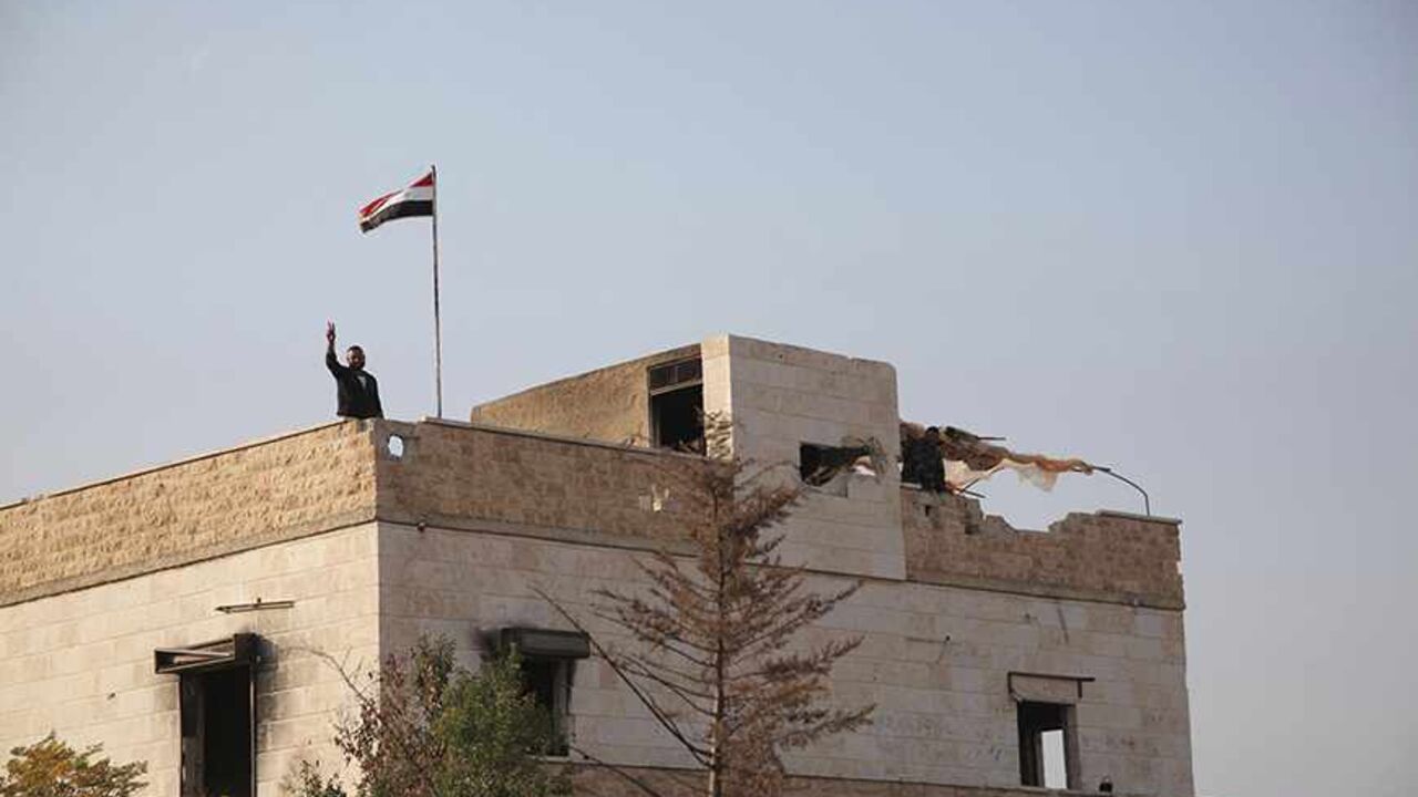 SYRIA-CRISIS Forces loyal to Syria's President Bashar al-Assad gesture atop a building in Aleppo countryside, November 16, 2013. Syrian forces backed by Lebanese Hezbollah militants recaptured Tel Chgab, Torkan, Tel Aabur, Abu Sfith and the way toTalrn, they said. REUTERS/George Ourfalian (SYRIA - Tags: POLITICS CIVIL UNREST CONFLICT MILITARY) - RTX15G7I