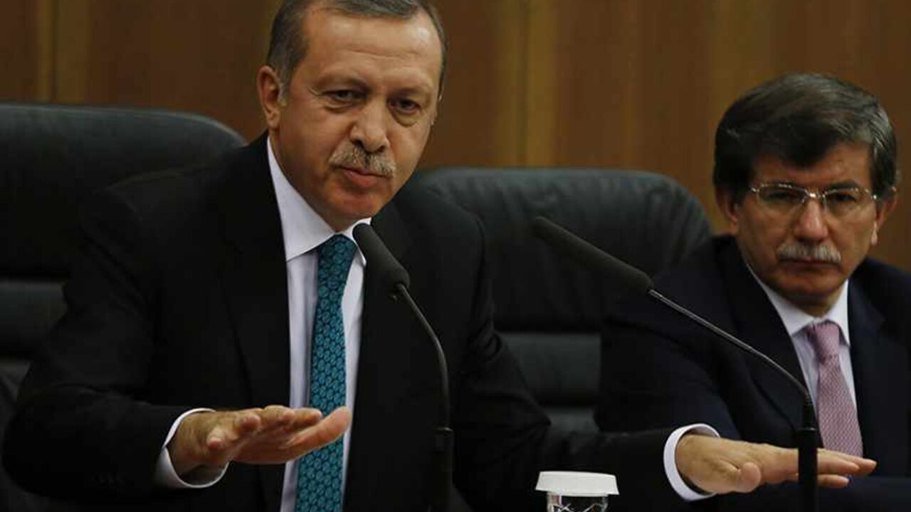 TURKEY-ERDOGAN/GULEN Turkish Prime Minister Tayyip Erdogan addresses the media next to Foreign Minister Ahmet Davutoglu (R) at Esenboga Airport in Ankara November 21, 2013. A feud between Erdogan and an influential Islamic cleric, Fethullah Gulen, has spilled into the open months ahead of elections, highlighting fractures in the religiously conservative support base underpinning his decade in power. REUTERS/Umit Bektas (TURKEY - Tags: POLITICS RELIGION) - RTX15NGG