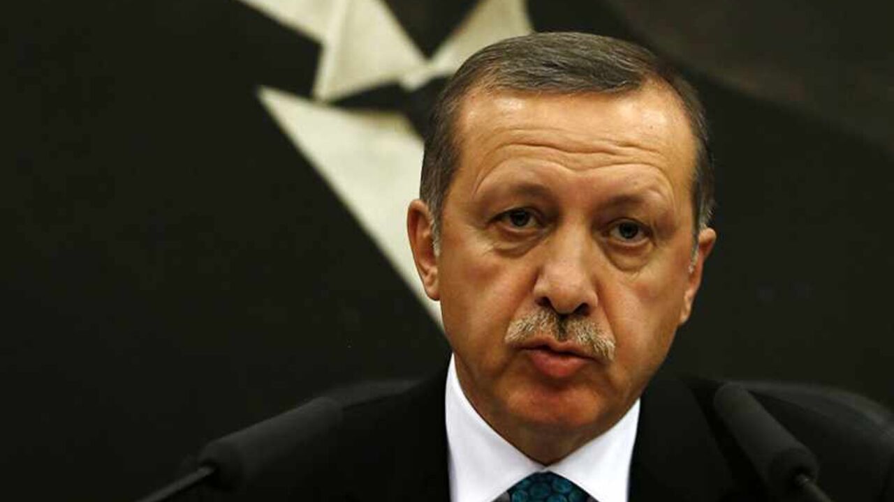 TURKEY-ERDOGAN/GULEN Turkish Prime Minister Tayyip Erdogan addresses the media as he sits in front of a portrait of Mustafa Kemal Ataturk, founder of secular Turkey, at Esenboga Airport in Ankara November 21, 2013. A feud between Erdogan and an influential Islamic cleric, Fethullah Gulen, has spilled into the open months ahead of elections, highlighting fractures in the religiously conservative support base underpinning his decade in power. REUTERS/Umit Bektas (TURKEY - Tags: POLITICS RELIGION) - RTX15NGN