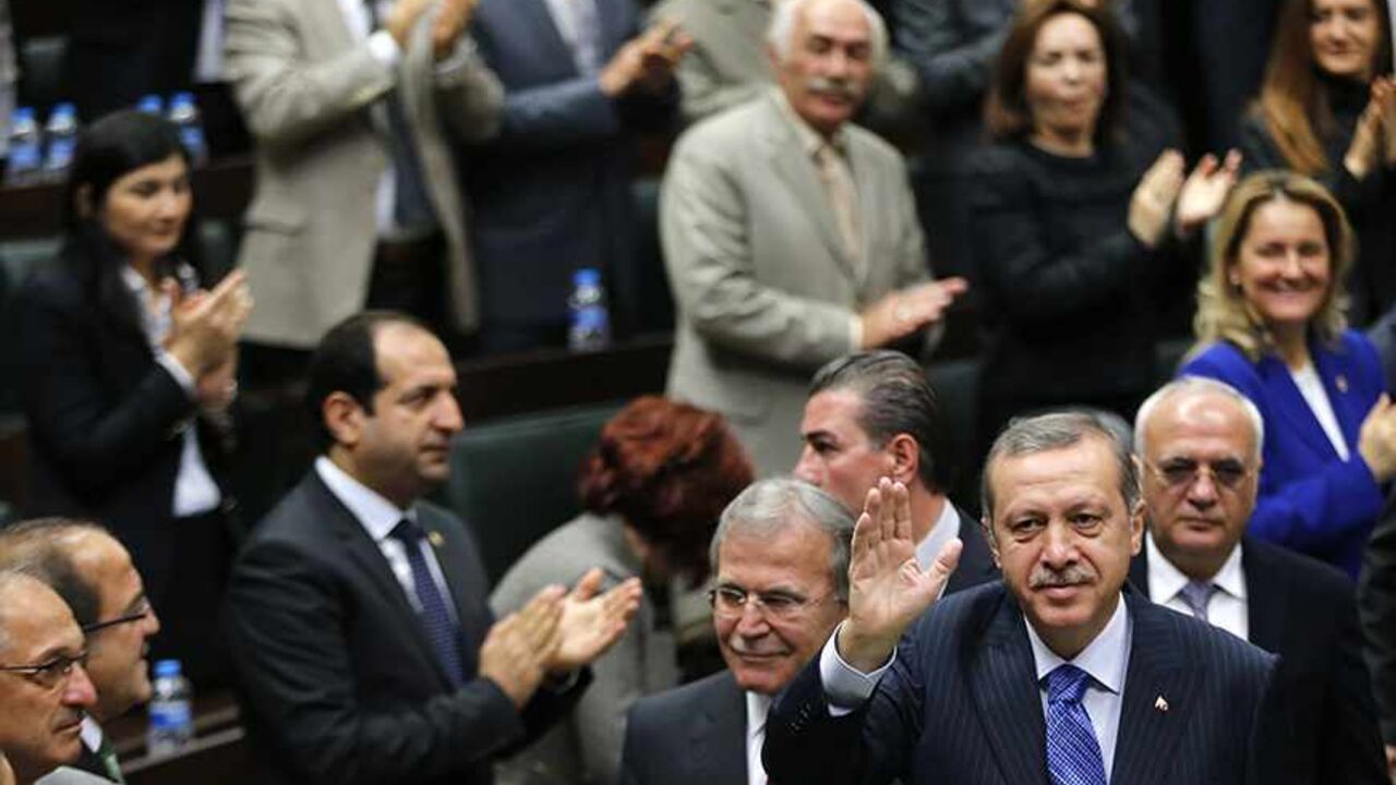 TURKEY-ERDOGAN/ Turkey's Prime Minister Tayyip Erdogan greets members of parliament from his ruling AK Party (AKP) during a meeting at the Turkish parliament in Ankara November 26, 2013. REUTERS/Umit Bektas (TURKEY - Tags: POLITICS) - RTX15TOG