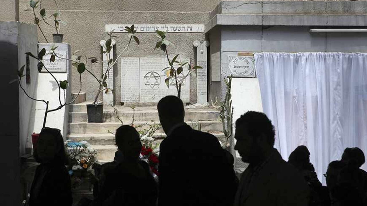 EGYPT-JEWS/ Diplomats from the United States and Israel are silhouetted as they join about 100 mourners at a ceremony, held on Thursday in memory of veteran Jewish leader Carmen Weinstein, at Sha'ar Hashamayim (Gate of Heaven) synagogue in downtown Cairo, April 18, 2013. Weinstein, 82, died last Saturday at her home in Cairo where she was known over the past two decades for leading efforts to preserve the overwhelmingly Muslim country's Jewish heritage. REUTERS/Asmaa Waguih (EGYPT - Tags: RELIGION POLITICS OBITUARY) -