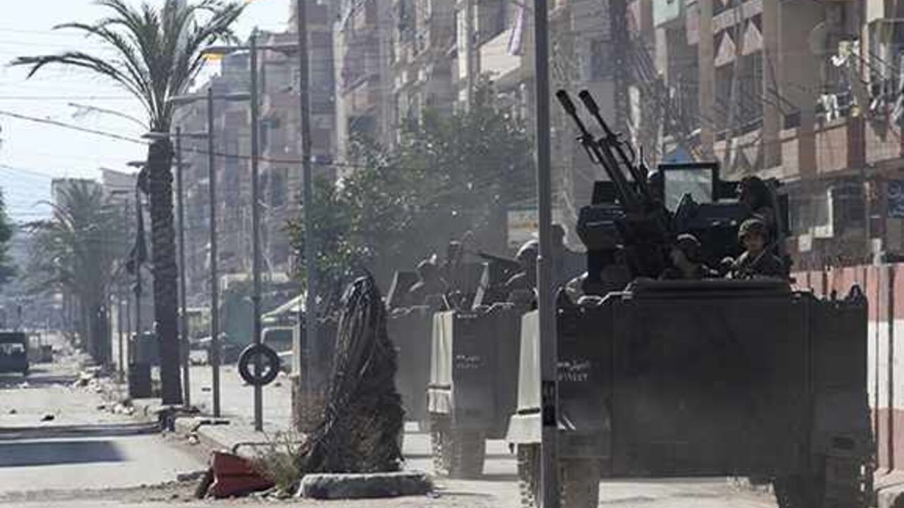 SYRIA-CRISIS/TRIPOLI Lebanese army soldiers ride on their military vehicles after being deployed to tighten security following days of clashes between Sunni Muslims and Alawites in the northern port city of Tripoli October 28, 2013. Two people died in the northern city of Tripoli on Monday, security and medical sources said, in fighting between supporters and opponents of Syrian President Bashar al-Assad and the Lebanese army which has spilled over from the war next door. REUTERS/Omar Ibrahim (LEBANON - Tags: POLITICS CIVIL U