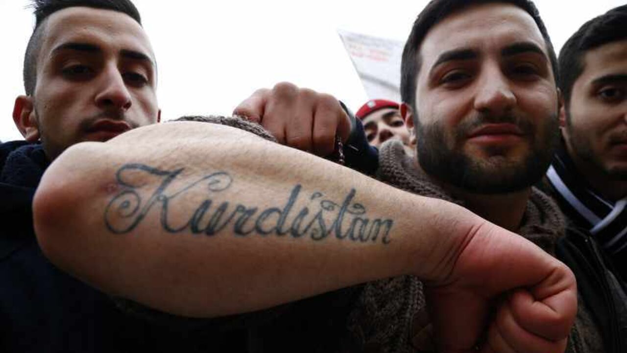Pro-Kurdish demonstrator displays tattoo as he attends rally against 20 year ban of PKK in Berlin A pro-Kurdish demonstrator displays his tattoo as she attends a rally marking the 20th anniversary of the introduction of a ban of the Kurdistan Workers Party (PKK) in Berlin November 16, 2013. REUTERS/Tobias Schwarz (GERMANY - Tags: POLITICS CIVIL UNREST) - RTX15G0V