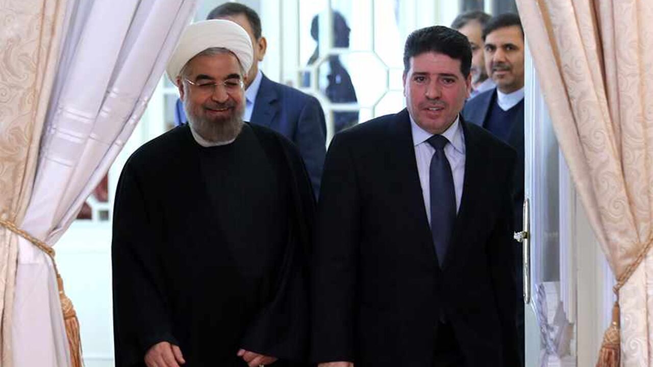 Nic6270980 Iranian President Hassan Rouhani (L) welcomes Syrian Prime Minister Wael al-Halaqi ahead of a meeting in Tehran on December 1, 2013. AFP PHOTO/ATTA KENARE (Photo credit should read ATTA KENARE/AFP/Getty Images)