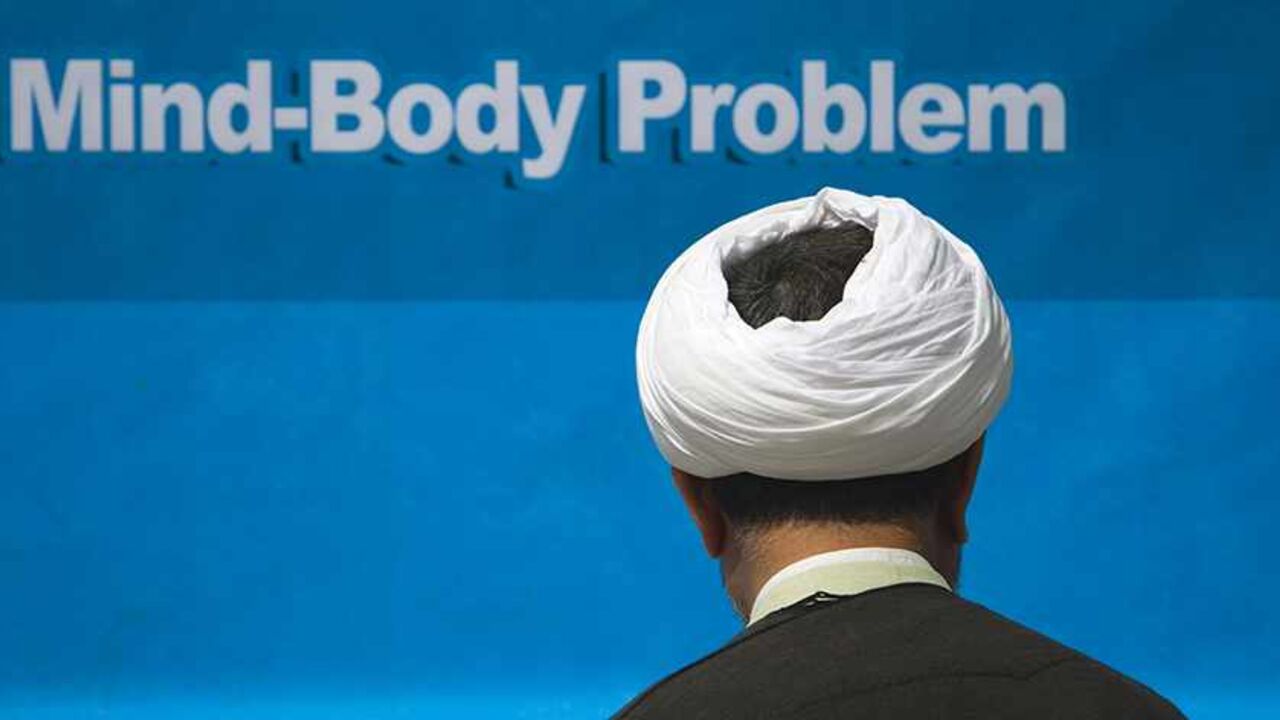 IRAN/ EDITORS' NOTE: Reuters and other foreign media are subject to Iranian restrictions on their ability to film or take pictures in Tehran.
A cleric stands in front of a banner as he arrives at a religious conference centre in Qom, 120 km (75 miles) south of Tehran, March 10, 2011. The clerics are attending the International Conference of Religious Doctrines and the Mind-Body Problem. REUTERS/Morteza Nikoubazl (IRAN - Tags: RELIGION) - RTR2JPSP