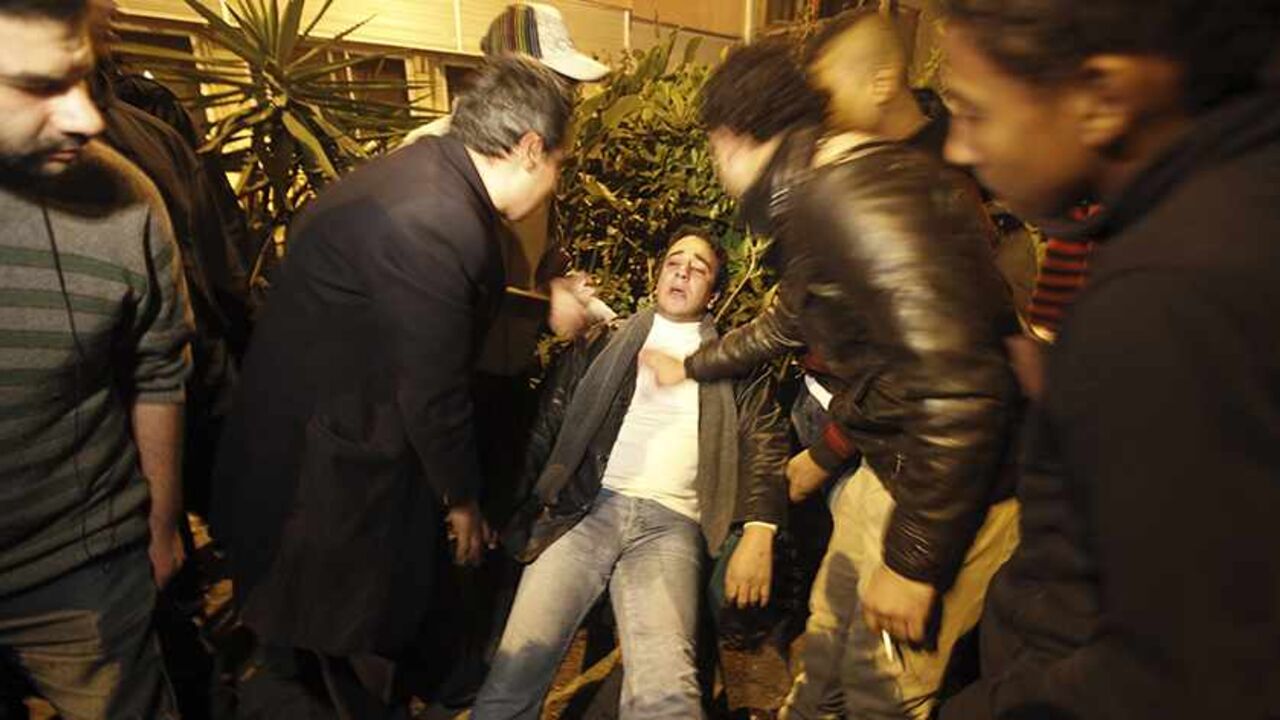 EGYPT-POLITICS-VIOLENCE An injured journalist is surrounded by other journalists after the Al Wafd headquarters was attacked by Islamists in Cairo December 15, 2012. Islamists attacked the opposition Wafd party's newspaper offices in central Cairo with petrol bombs and birdshot on Saturday, security sources said. The violence flared as Egyptians voted in a referendum on a new constitution intended to pull the country out a growing political crisis. Two people were injured and firefighters said they had put out the flames, a Reuter