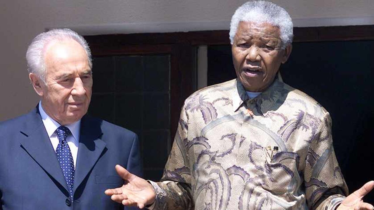 SAFRICA SUMMIT Former South African president Nelson Mandela (R) speaks to journalists
next to Israeli Deputy Prime Minister Shimon Peres (L) outside his
office after their meeting in Johannesburg, September 3, 2002, during
the World Summit on Sustainable Development. REUTERS/Juda Ngwenya
JN/CRB - RTR9RLR