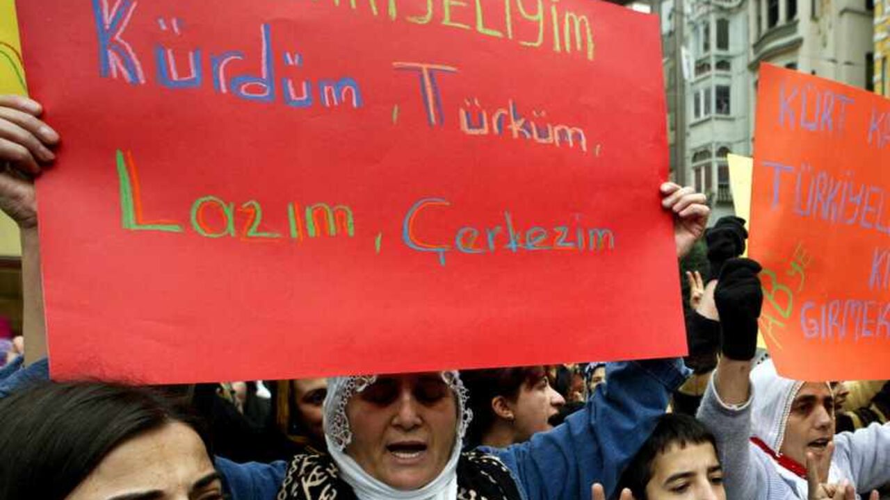 Protesters mostly Kurdish women uphold placards during a demonstration in Istanbul. Demonstrators shout slogans as they hold up banners while staging a protest in central Istanbul December 11, 2004. Hundreds of protesters formed a human chain through the busy shopping street of Istiklal on Saturday to protest the recent killing of a 12-year-old boy and his father by security forces in Kiziltepe in the southeast Turkish province of Mardin which is now under investigation. Banner at left reads in Turkish "I am Turkish, Kurdish, Circassian and Laz from Turkey" and the banner at top right read