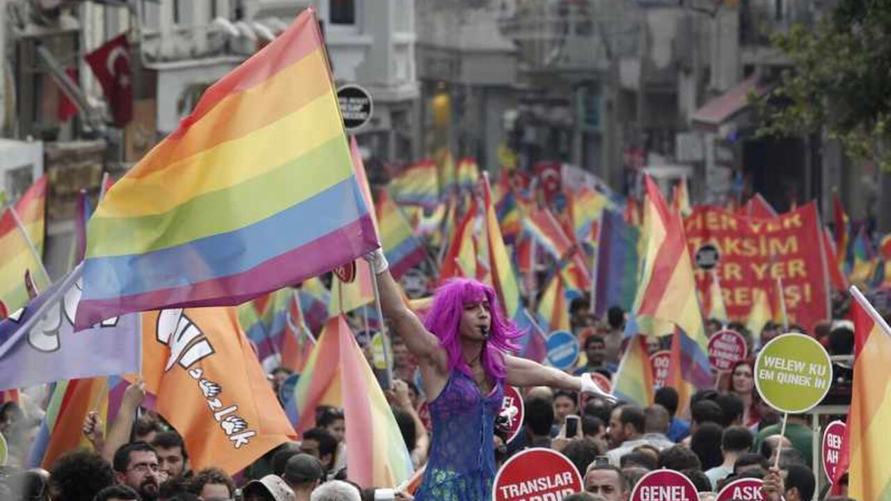 A participant holds a rainbow flag during a gay pride parade in central Istanbul A participant holds a rainbow flag during a gay pride parade in central Istanbul June 30, 2013. Tens of thousands of anti-government protesters teamed up with a planned gay pride march in Istanbul. Crowds were stopped by riot police from entering Taksim, the centre of previous protests, but the atmosphere appeared peaceful. REUTERS/Osman Orsal (TURKEY - Tags: CIVIL UNREST POLITICS SOCIETY) - RTX1176G